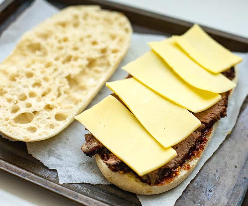 Sliced cheese on a steak sandwich