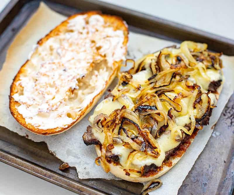 Grilled onions on top of cheese steak sandwich